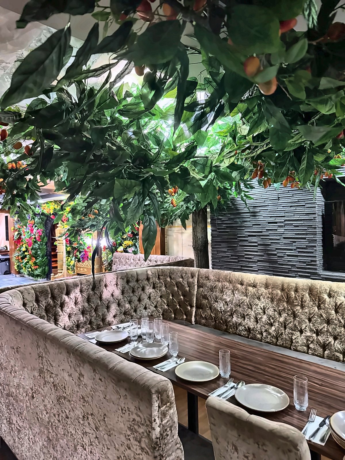 Velvet booth seating under hanging greenery at 3 Five 1